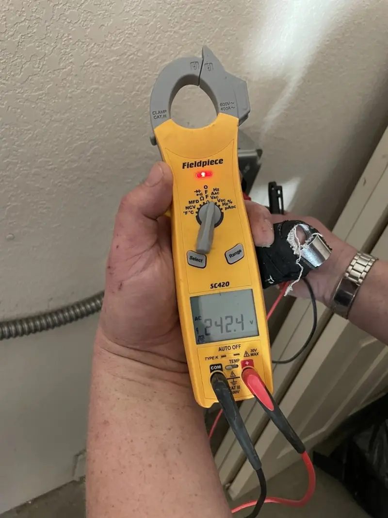 Voltage testing with clamp meter during Whole House Surge Protector in Warren